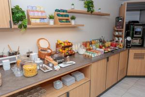 a kitchen counter with a bunch of food on it at Cristal Hôtel & Spa in Cannes
