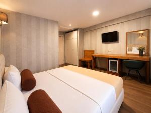 a hotel room with a large bed and a desk at Kuzen Otel in Istanbul