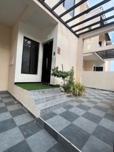 a house with stairs leading to a door at Maxi villa maamalla in Mahabalipuram