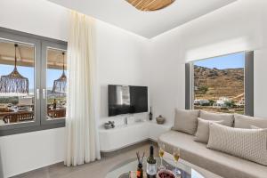a living room with a couch and a tv at Naxian Pearl in Mikri Vigla