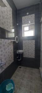 a black bathroom with a sink and a window at Steep Valley Resort in Kotagiri