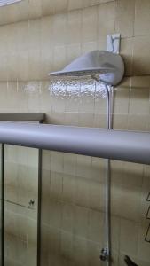 a bathroom with a sink and a toilet on a shelf at Quarto suite 1 dorm Prox da Casa de Saude mais salas e estacionamento in Santa Maria +89 photos