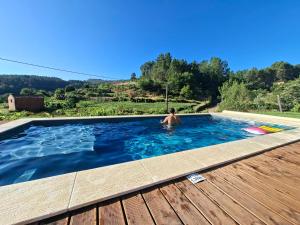 a man in a swimming pool in a house at Quinta da Peça Douro Wine Region Retreat, Private Pool Villa in Vila Real