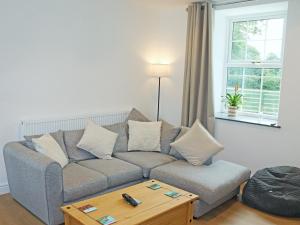 a living room with a couch and a coffee table at Gate House in Llangefni