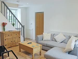 a living room with a couch and a coffee table at Gate House in Llangefni