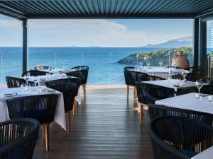 a restaurant with tables and chairs and a view of the ocean at La Toubana Hotel & Spa in Sainte-Anne +31 photos