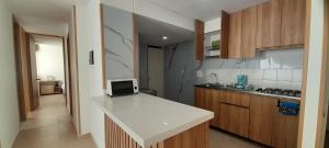 a kitchen with a white counter top and wooden cabinets at Apartment Neiva Rasan in Neiva