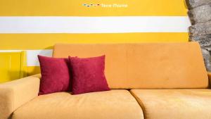 a brown couch with two purple pillows on it at Sky & Sea, Terre Marine in Volastra