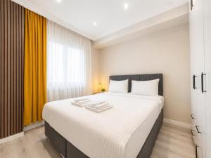 a bedroom with a large bed with towels on it at Casa Florya Suites in Istanbul