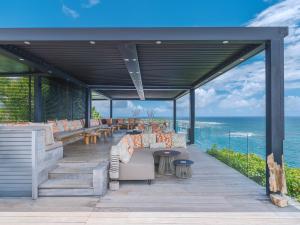 a pavilion with chairs and a view of the ocean at La Toubana Hotel & Spa in Sainte-Anne