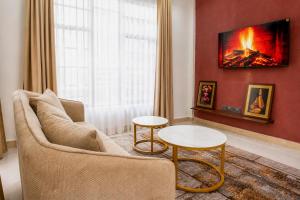 a living room with a couch and a table at NioneEdge-Arusha-Moshono in Themi