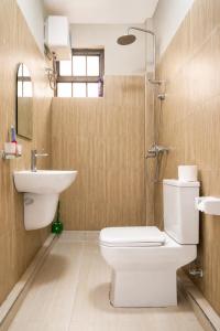 a bathroom with a toilet and a sink at NioneEdge-Arusha-Moshono in Themi +6 photos