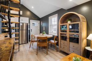 a dining room with a table and a bunk bed at Pelican Cliff Cottage - Tiny Home at Hampton Beach in Hampton +15 photos