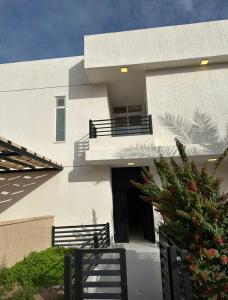 a large white building with a door and a balcony at Diva Chalet in Sowayma