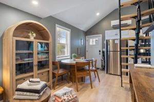 a kitchen and dining room with a table and chairs at Sandy Toes Cottage - Tiny Home at Hampton Beach in Hampton