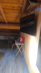 a room with a desk with a keyboard and a television at Mas de chalvagne in Val-de-Chalvagne
