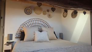 a bedroom with a bed with a wooden headboard at Mas de chalvagne in Val-de-Chalvagne