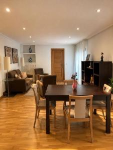 a living room with a wooden table and chairs at Casa Turística Mareira O Grove in O Grove