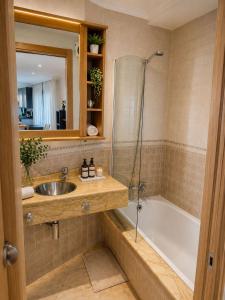a bathroom with a sink and a bath tub at Casa Turística Mareira O Grove in O Grove