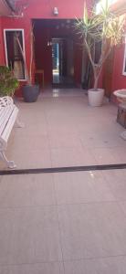 a patio with a white bench and potted plants at Hotel Centro in Copiapó +7 photos