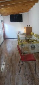 a room with tables and chairs and a red chair at Hotel Centro in Copiapó