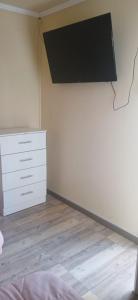 a bedroom with a dresser and a tv on the wall at Hotel Centro in Copiapó
