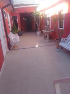 a courtyard with benches and potted plants in a building at Hotel Centro in Copiapó