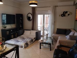 a living room with a couch and a table at LenasApartment in Valanidorachi
