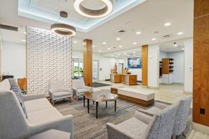 a waiting room at a hospital with chairs and tables at Holiday Inn Express & Suites Salt Lake City South-Murray by IHG in Murray +59 photos