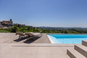 a view of a swimming pool with a table and chairs at Persolis luxury sun residence in Kojsko