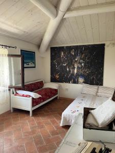 a living room with two beds and a red couch at Casa da Antonia 850 ASL in Ronchi