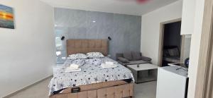 a bedroom with a bed and a chair at Taksim Apartman in Igalo