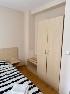 a white bedroom with a bed and a cabinet at Apartment Amelia in Rogachevo +14 photos