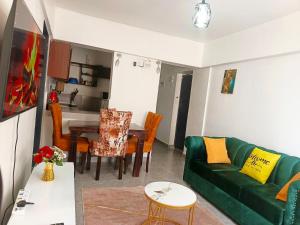 a living room with a green couch and a table at 1&2&3bedroom KlenCBDMilimani apartments in Kisumu