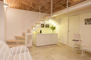 a living room with a staircase in a loft at Murgia Dreams in Altamura