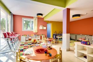 a childs play room with a table and chairs at Barceló Palmeraie Oasis Resort in Marrakesh