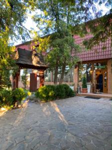 a building with a stone driveway in front of a building at Stizhok Hotel & Restaurant in Berkhomet-pe-Siret