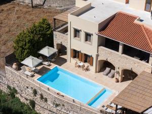 an aerial view of a villa with a swimming pool at Ilys Home, a Country-chic Retreat with Pool & BBQ, By ThinkVilla in Margarítai