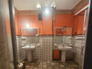 a bathroom with two sinks and two mirrors at Fabrica de Sueños in Gandía +24 photos