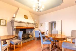 a dining room with tables and chairs and a fireplace at La Rocca di Camporgiano in Camporgiano