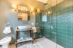 a bathroom with a glass shower and a sink at La Rocca di Camporgiano in Camporgiano +158 photos