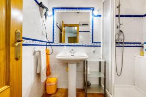 a bathroom with a sink and a mirror at Carrebaix Loft in Orba +23 photos