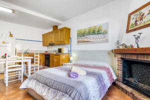 a bedroom with a bed and a fireplace at Carrebaix Loft in Orba