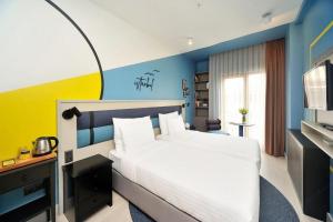 a bedroom with a white bed and a blue wall at BoStay Hotel in Istanbul