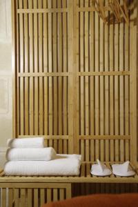 a cage with three towels and two pairs of shoes at Dimora Antica Santa Chiara in Trani +20 photos