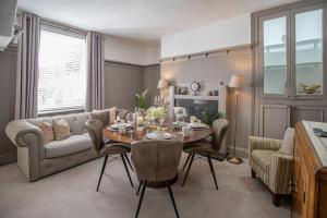 a living room with a table and a couch at Hudson House in Durham