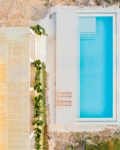 an overhead view of a swimming pool next to a building at Villa Kweli - Private Ocean Front Villa in Tongoni