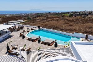 a swimming pool on top of a house at Oikos Santorini Living Concept in Fira