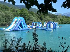 a group of inflatable slides in a lake at Le refuge du poète in Saint-François-de-Sales