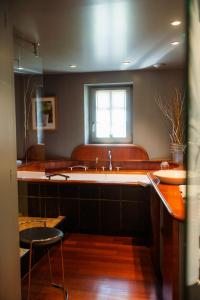 a large kitchen with a sink and a window at Hôtel le Moulin in Gundershoffen